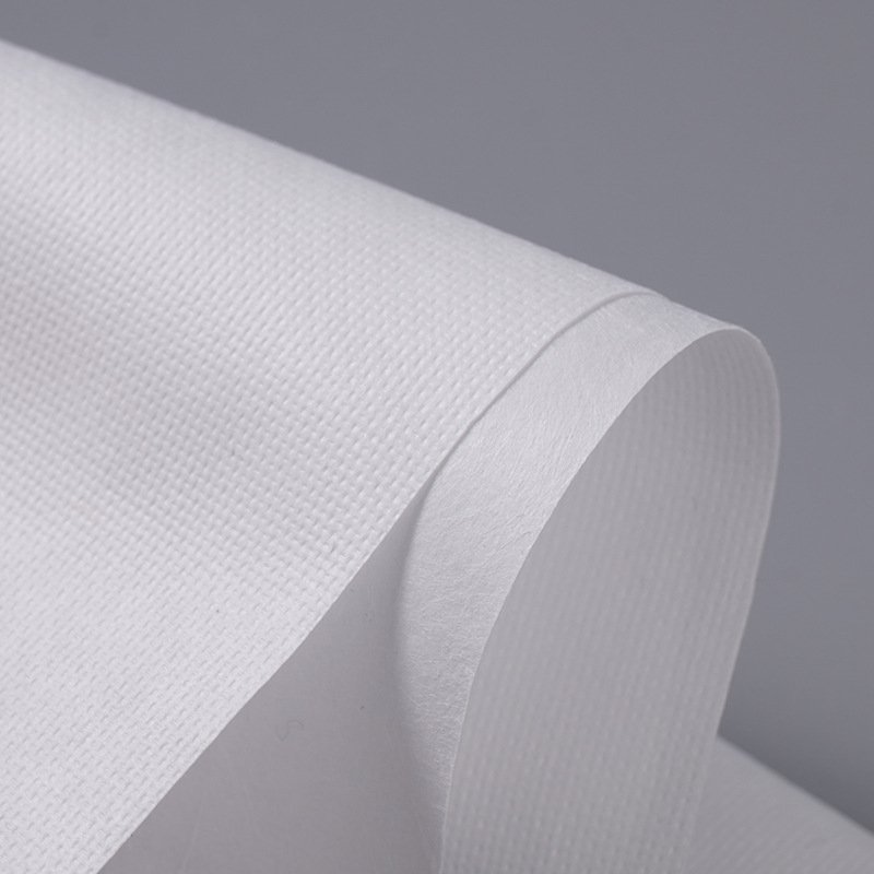 Close-up of white polypropylene meltblown non-woven fabric showing microfiber structure. Used for air filter media, water filter layers, N95 respirator middle layer, medical face mask filtration, disposable protective gowns, sanitary napkin absorbent core wrap, and diaper non-woven layer.