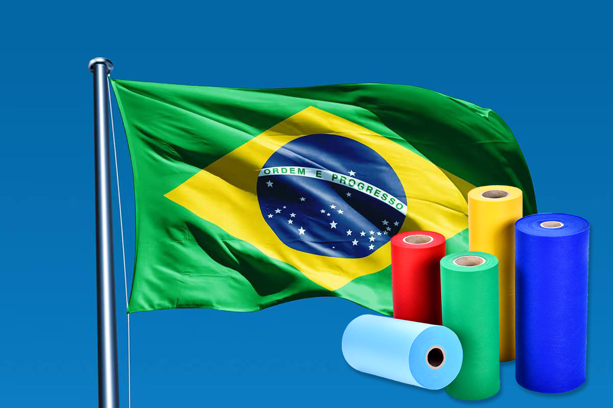 Brazilian flag with rolls of colorful non-woven fabric in green, yellow, red, blue and light blue, representing high-quality non-woven materials for the Brazilian market