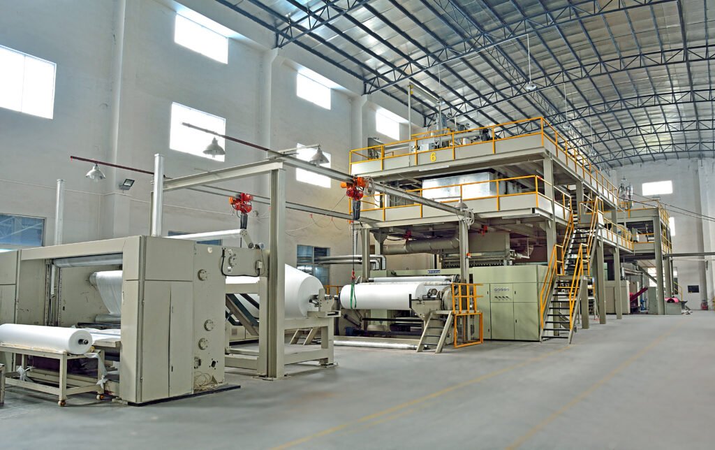 This is the workshop of a non-woven fabric manufacturer in China, where two high-speed production lines are producing white non-woven fabric for use in furniture, mattresses, sofas, surgical gowns, electronics packaging, and more.