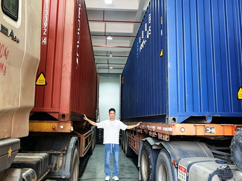 Sales representative standing between two containers waiting to be loaded with Takewind nonwoven fabric, reflecting global customer trust and bulk order shipment capacity