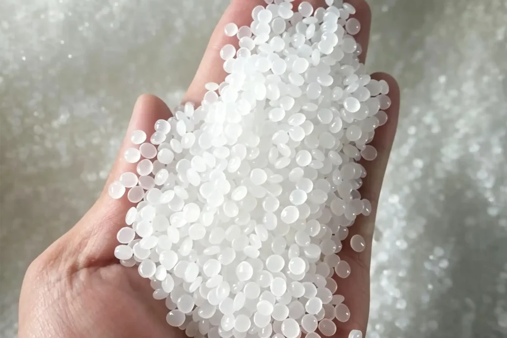 Hand holding 100% virgin PP polypropylene pellets, raw material for Takewind spunbond non woven disposable tablecloth