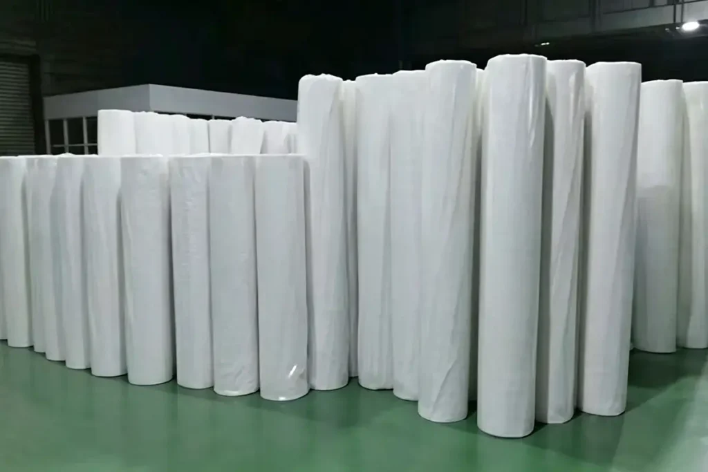 Neatly arranged virgin PP nonwoven fabric rolls for pillow insert and garment interlining storage in Takewind factory warehouse