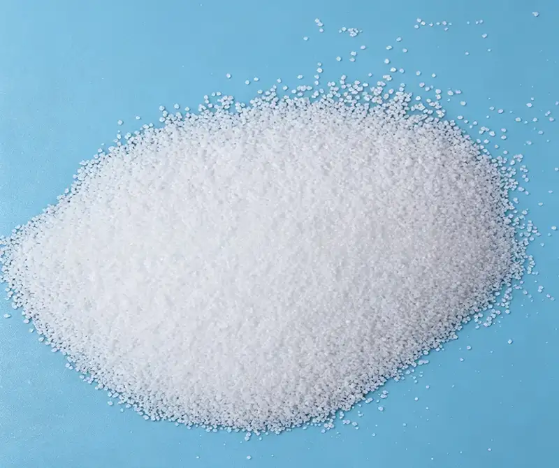 White granular PP polypropylene powder, raw material for PP spunbond nonwoven manufacturing, overhead shot on solid sky blue background