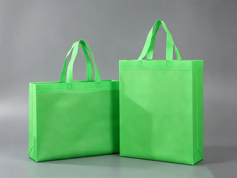 two bright green non woven tote bags with reinforced handles, reusable eco nonwoven shopping bags, Takewind packaging bag products